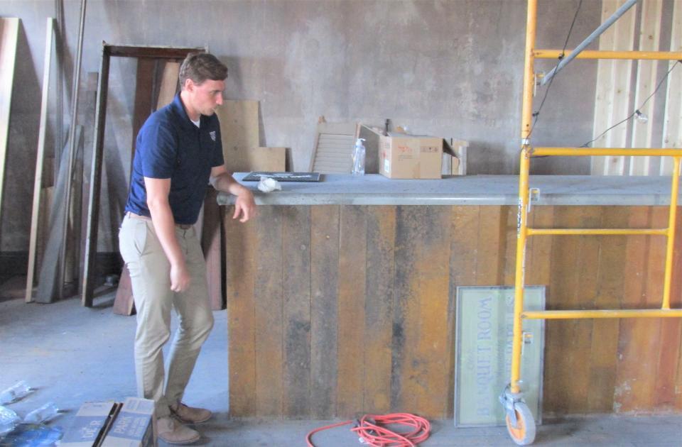 Dylan Kaufman describes the bar made using wood from the existing structure on the third floor of the American Hall building in downtown Millersburg. The bar is part of the reception hall on the third floor of the building.