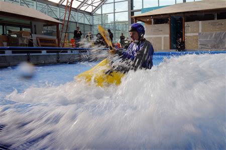 Jeff Fluet, from NH Kayak Center, tests the waves in a kayak in the still under-construction Surf's Up indoor water and surf park in Nashua, New Hampshire November 15, 2013. REUTERS/Brian Snyder