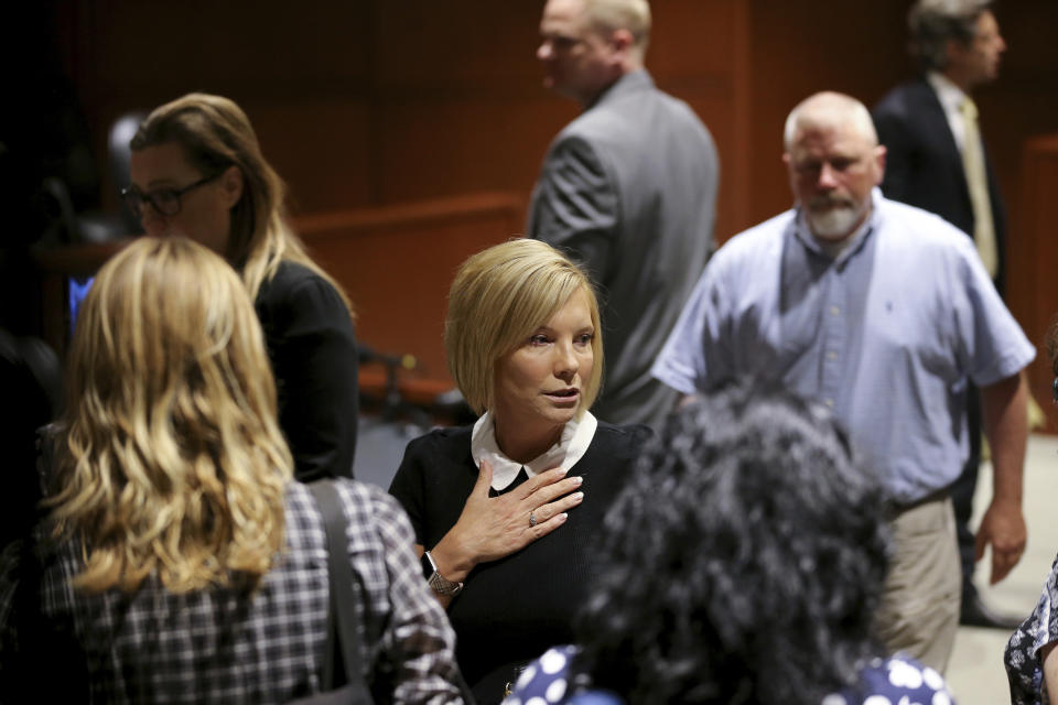 Kim Richardson, center, walks out of the courtroom after her daughter Brooke Skylar Richardson was sentenced, Friday, Sept. 13, 2019, in Lebanon, Ohio. Richardson, acquitted the day before of killing her newborn but convicted of corpse abuse, was sentenced to three years' probation, was sentenced to three years' probation. (Kareem Elgazzar/The Cincinnati Enquirer via AP, Pool)