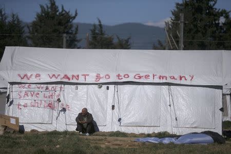 A man sits outside a tent at a makeshift camp for refugees and migrants at the Greek-Macedonian border near the village of Idomeni, Greece, April 15, 2016. REUTERS/Stoyan Nenov