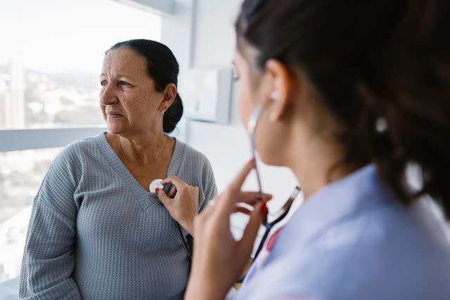 <p>Getty</p> Nurse listening to patient's heartbeat through stethoscope.