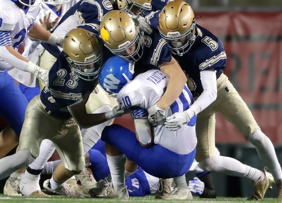 Aquinas High School's Tony Miller (23), Trey Bahr (9) and Declan Hass (5) tackle Wrightstown High School's Payton Vande Hey (10) during their Division 5 state championship football game on Thursday, November 16, 2023, at Camp Randall Stadium in Madison, Wis. Aquinas defeated Wrightstown 32-13.
Wm. Glasheen USA TODAY NETWORK-Wisconsin