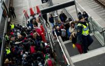 Police organise migrants at Hyllie train station outside Malmo, Sweden, on November 19, 2015