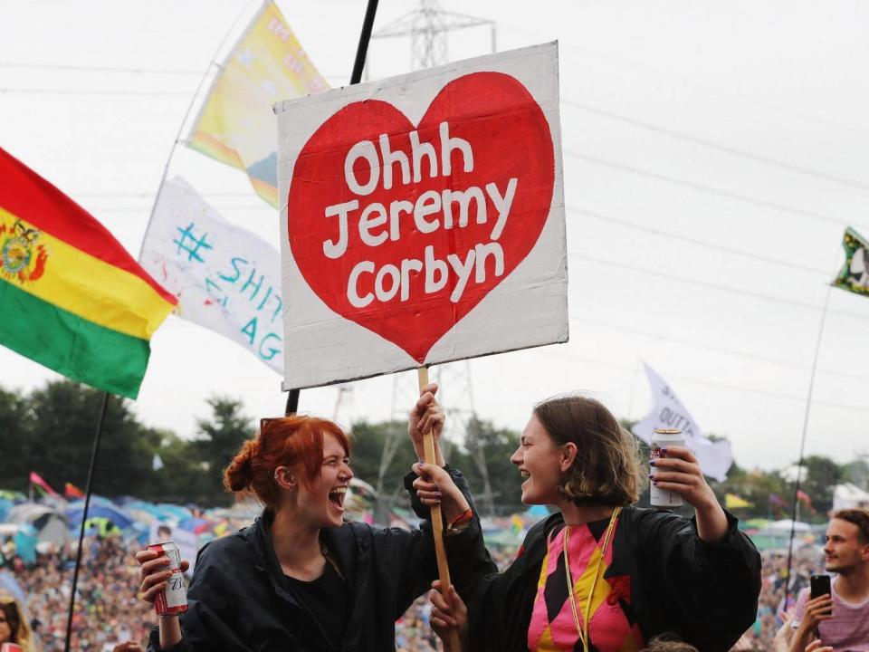 Festivalgoers with a flag supporting Labour party leader Jeremy Corbyn seen as he makes a guest appearance at the Glastonbury Festival Site on June 24, 2017 (Getty)