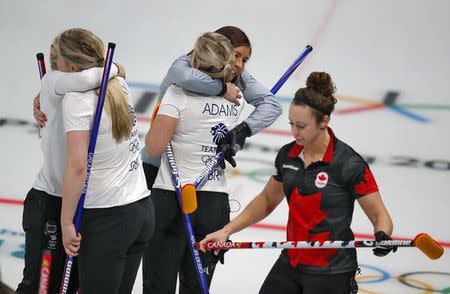 Curling - Pyeongchang 2018 Winter Olympics - Women's Round Robin - Britain v Canada - Gangneung Curling Center - Gangneung, South Korea - February 21, 2018 - Anna Sloan, Eve Muirhead, Vicki Adams and Lauren Gray of Britain celebrate their win past Joanne Courtney of Canada. REUTERS/Phil Noble