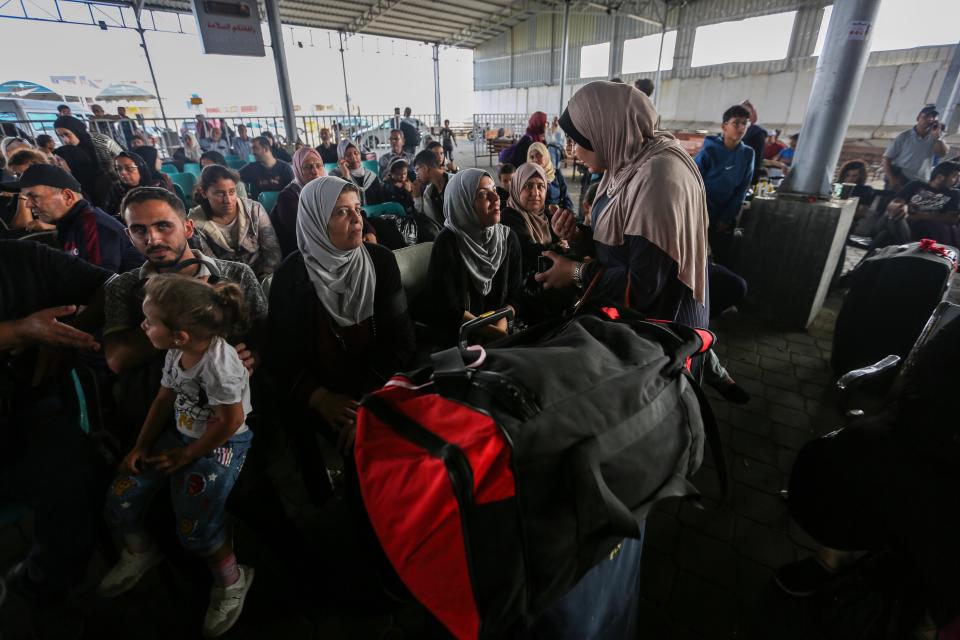 Citizens with foreign passports wait to travel through the Rafah crossing on Nov. 2, after the Gaza-Egyptian border opened for the first time to allow a small number of foreign passport holders and seriously wounded to enter Egypt.