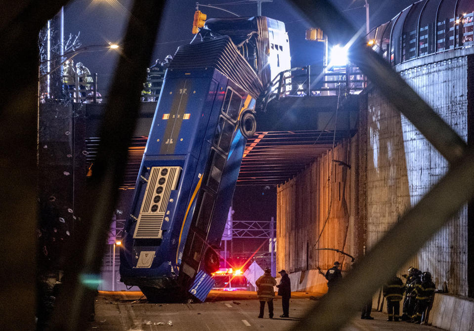 Image: A bus in New York City which careened off a road in the Bronx neighborhood of New York is left dangling from an overpass F (Craig Ruttle / AP)