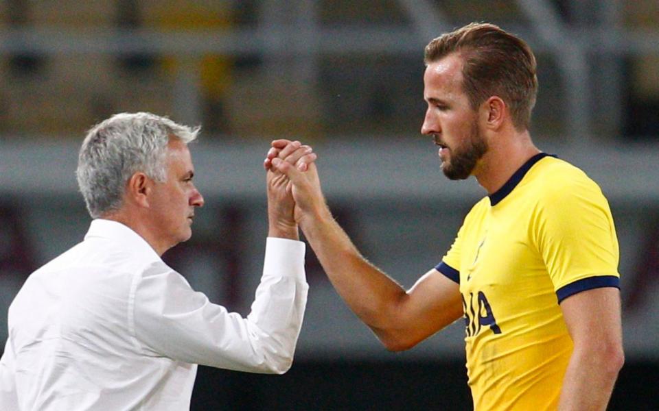 Tottenham Hotspur manager Jose Mourinho shakes hands with Harry Kane - Reuters