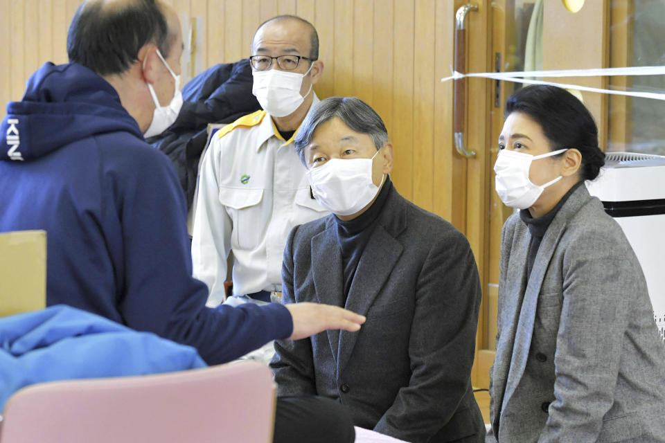 Japanese Emperor Naruhito, front center, and Empress Masako meet a victim of the deadly Jan. 1 earthquakes, at a shelter in Wajima, Ishikawa prefecture, Japan Friday, March 22, 2024. (Kyodo News via AP)