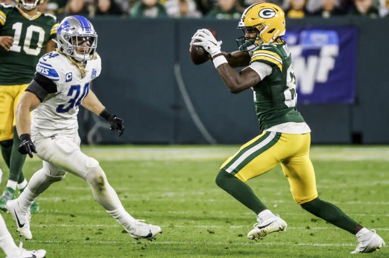 Green Bay Packers wide receiver Romeo Doubs (R) catches a pass in front of Detroit Lions linebacker Alex Anzalone on Thursday at Lambeau Field in Green Bay, Wis. Photo by Tannen Maury/UPI