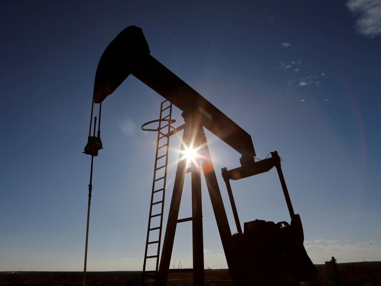 FILE PHOTO: The sun is seen behind a crude oil pump jack in the Permian Basin in Loving County, Texas, U.S., November 22, 2019. REUTERS/Angus Mordant