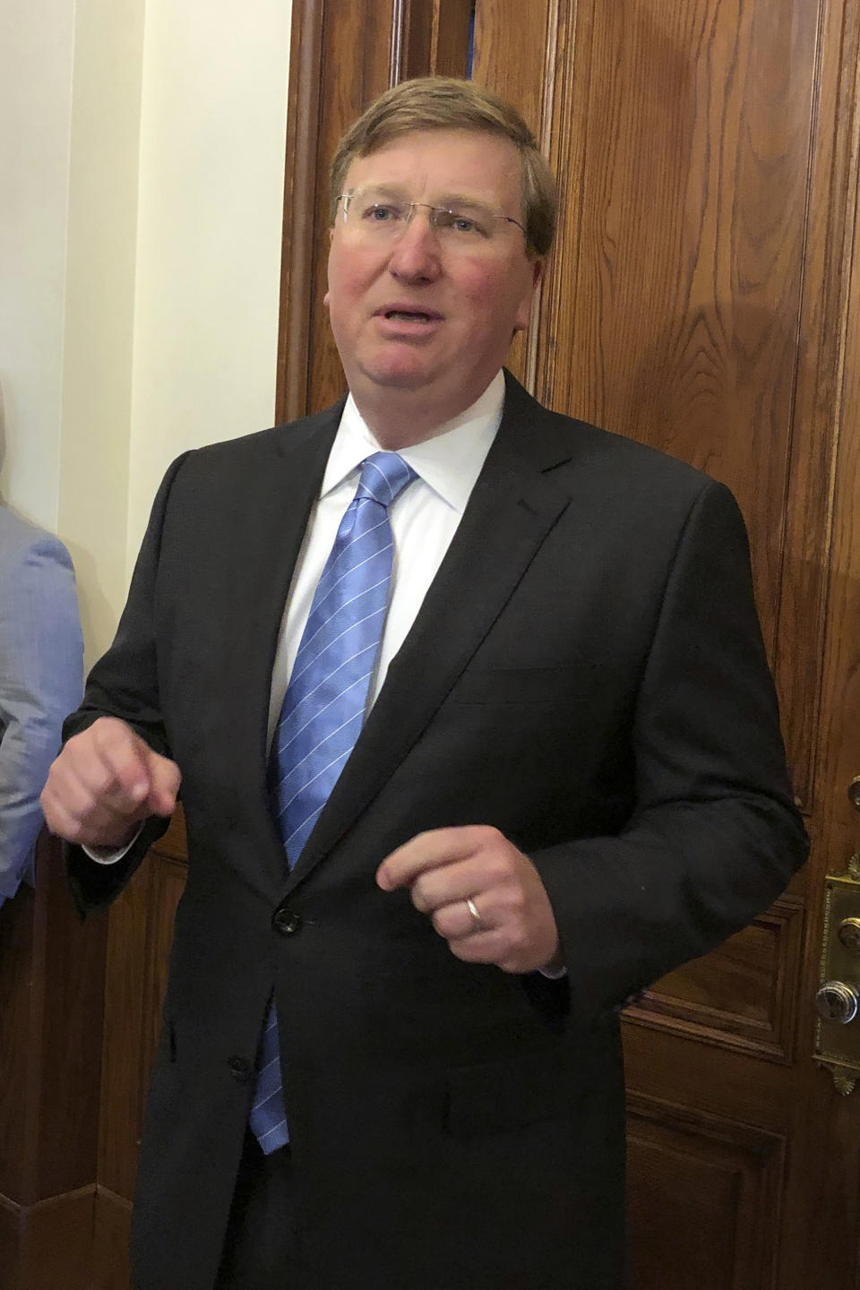 Mississippi Gov. Tate Reeves speaks Thursday, March 24, 2022, during a news conference outside his Capitol office in Jackson, Miss. The Republican says he wants legislators to phase out the state income tax. (AP Photo/Emily Wagster Pettus)