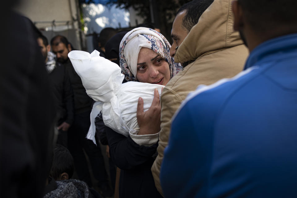 Palestinians mourn relatives killed in the Israeli bombardment of the Gaza Strip at a hospital morgue in Rafah, Wednesday, Feb. 21, 2024. (AP Photo/Fatima Shbair)