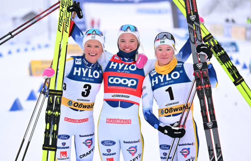 (L-R) Swedish cross-country skiers Frieda Karlsson, winner Linn Svahn and Jonna Sundling celebrate at the finish line after the final of the cross-country skiing World Cup in the classic sprint discipline. Martin Schutt/dpa