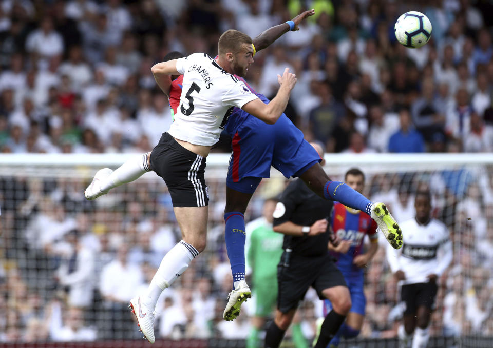 Fulham's Calum Chambers, left, and Crystal Palace's Max Meyer in action during their English Premier League soccer match at Craven Cottage in London, Saturday Aug. 11, 2018. (Yui Mok/PA via AP)