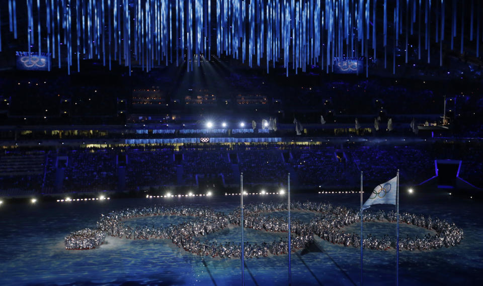 Artists make a formation in the shape of the Olympic Rings, with the last ring yet to open, during the closing ceremony of the 2014 Winter Olympics. (AP Photo)