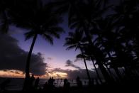 Spectators line the beach to view the total solar eclipse on November 14, 2012 in Palm Cove, Australia.