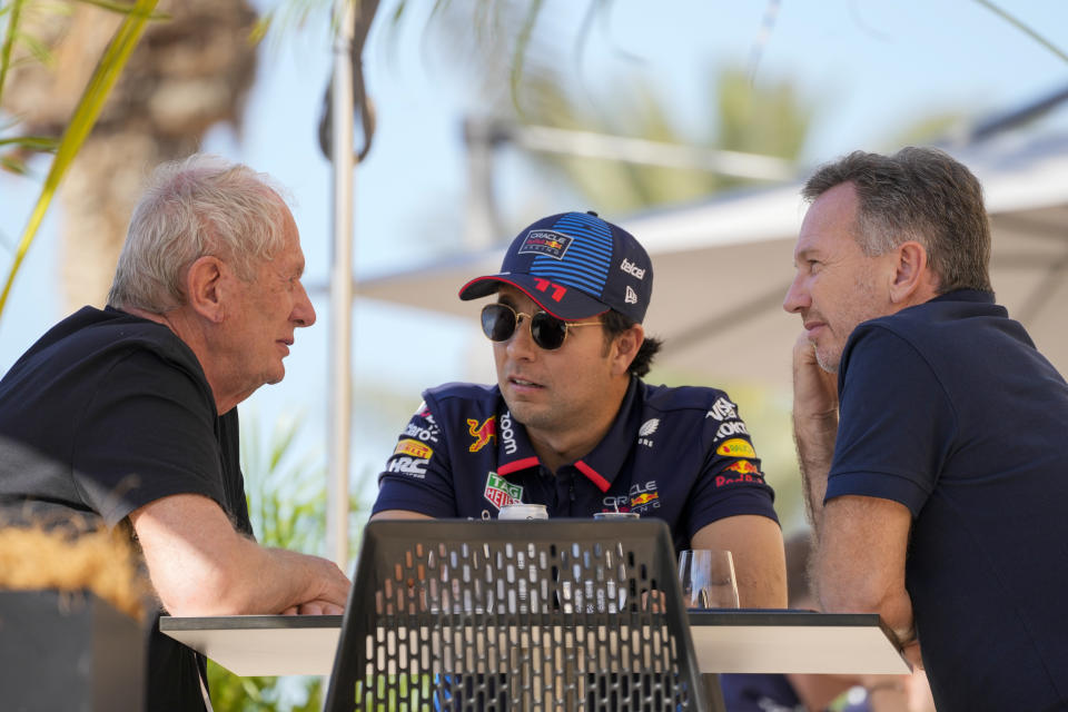 Red Bull team principal Christian Horner, right, chats with Red Bull driver Sergio Perez of Mexico, centre, and Helmut Marko, director of the Red Bull Formula One teams, left, at the pits during Formula One pre season test at the Bahrain International Circuit in Sakhir, Bahrain, Wednesday, Feb. 21, 2024. (AP Photo/Darko Bandic)