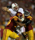 LOS ANGELES, CA - OCTOBER 29: Quarterback Andrew Luck #12 of the Stanford Cardinal is hit after throwing a pass by defensive linemen Wes Horton #96 and Dajohn Harris #98 of the USC Trojans at the Los Angeles Memorial Coliseum on October 29, 2011 in Los Angeles, California. (Photo by Stephen Dunn/Getty Images)