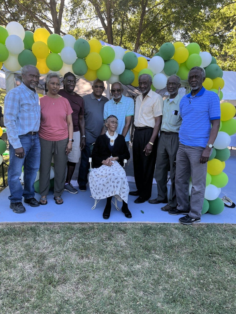 Alice McCluney, center, with her children Donald, Maxine, Paul, Joe, Holland, Thomas, John, and Earnest, at her 104th birthday party.