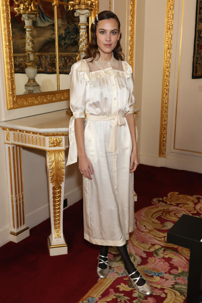 <p>Alexa Chung is Simone Rocha’s go-to muse and for good reason, as the model donned a silky number with pearl-embroidered hair grips. <em>[Photo: Getty]</em> </p>