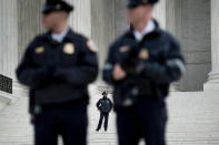 <p>Police guard the outside the US Supreme Court while arguments in the Masterpiece Cakeshop vs. Colorado case are heard Dec. 5, 2017 in Washington. (Photo: Brendan Smialowski/AFP/Getty Images) </p>