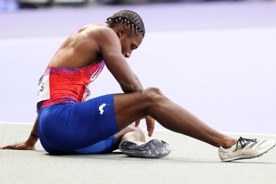 American Noah Lyles sits on the track after winning the bronze medal during in the 200-meter final Thursday in Paris.