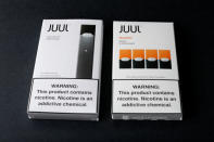 An electronic cigarette device made by JUUL (L) and its vaping pods are shown in this picture illustration taken September 14, 2018. REUTERS/Mike Blake/Illustration