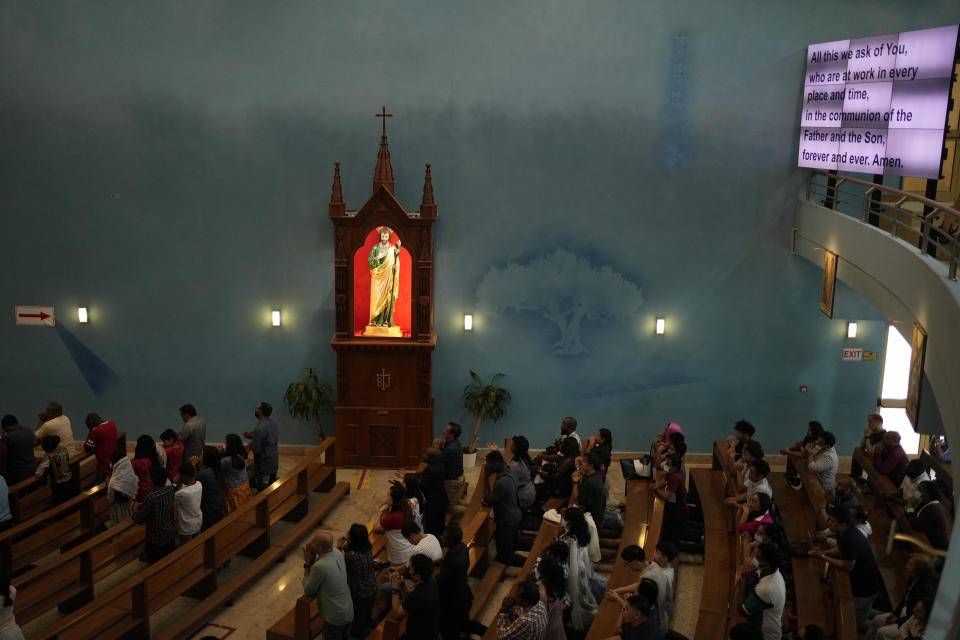 People take part in a liturgy at the Catholic Church, Our Lady of the Rosary, at the Religious complex, in Doha, Qatar, Friday, Dec. 9, 2022. (AP Photo/Thanassis Stavrakis)