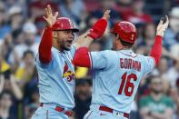 St. Louis Cardinals' Nolan Gorman (16) and Willson Contreras celebrate after scoring on a throwing error by Boston Red Sox's Enrique Hernandez during the ninth inning of a baseball game, Saturday, May 13, 2023, in Boston. (AP Photo/Michael Dwyer)