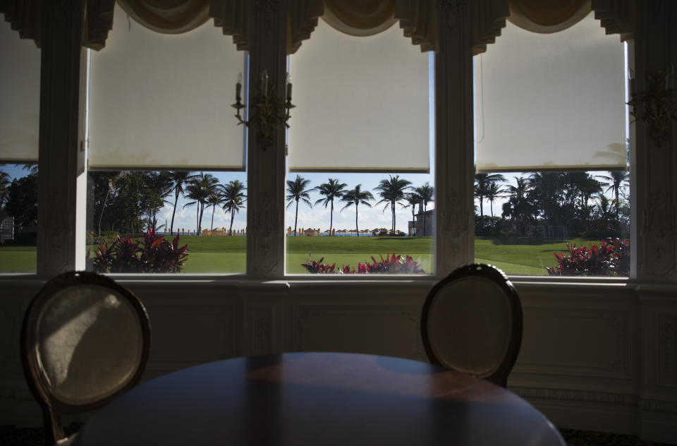 FILE - A dining area overlooks the lawns and water at President Donald Trump's Mar-a-Lago estate on Christmas Eve in Palm Beach, Fla., Dec. 24, 2017. (AP Photo/Carolyn Kaster, File)