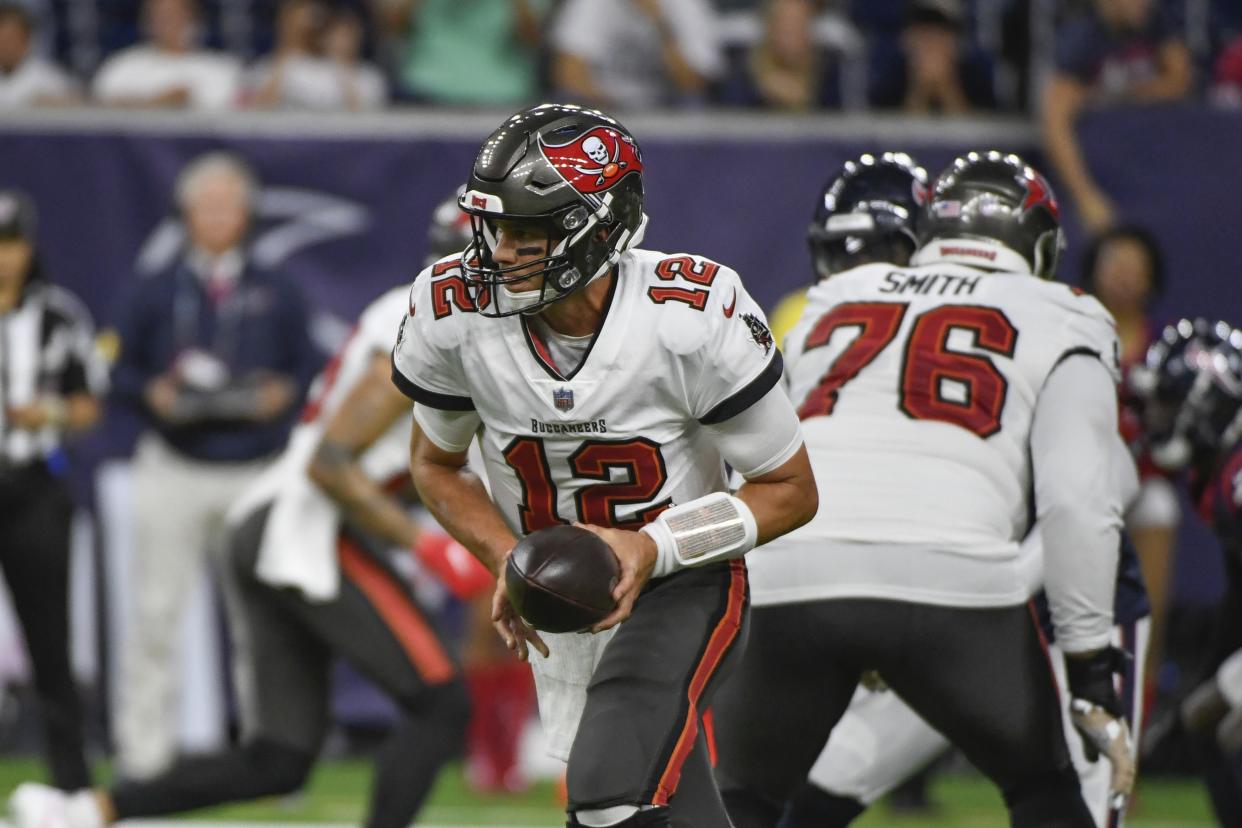 Tampa Bay Buccaneers quarterback Tom Brady (12) hands off the ball against the Houston Texans during the first half of an NFL preseason football game Saturday, Aug. 28, 2021, in Houston. (AP Photo/Justin Rex)