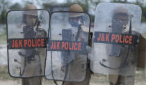 Special police officer recruits who completed nearly three months physical training demonstrate their skills at Kathua in Indian-controlled Kashmir, Saturday, June 5, 2021. Special police officers are lower-ranked police officials who are mainly recruited for intelligence gathering and counterinsurgency operations. In recent years, the force has assisted in border areas as well because of local recruits' familiarity with the topography and ability to assist police and border guards during emergencies. (AP Photo/Channi Anand)