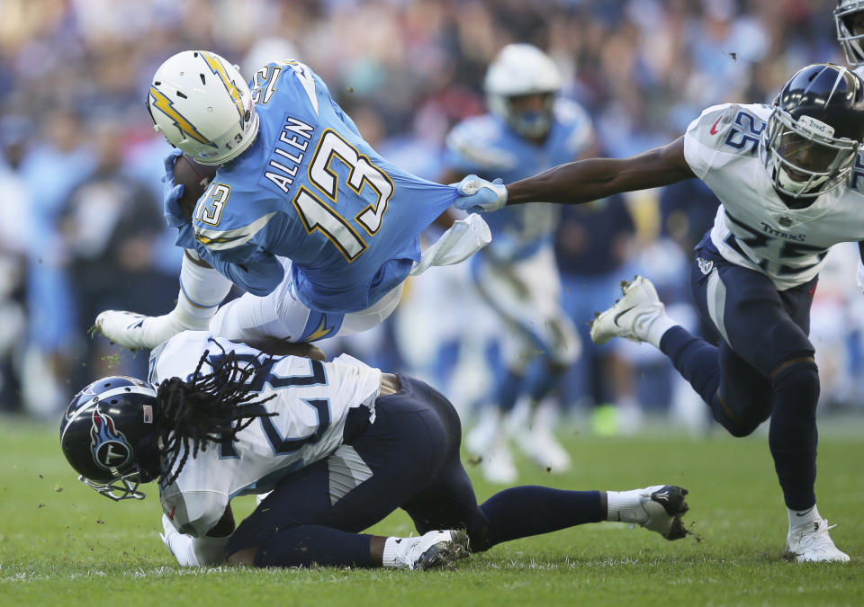 <p>Los Angeles Chargers wide receiver Keenan Allen (13) is tackled during the first half of an NFL football game against Tennessee Titans at Wembley stadium in London, Sunday, Oct. 21, 2018. (AP Photo/Tim Ireland) </p>