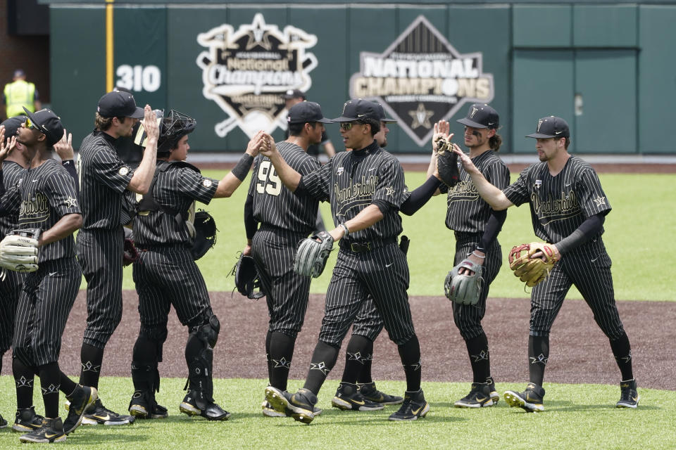 Vanderbilt players celebrate after beating East Carolina 2-0 in an NCAA college baseball super regional game Friday, June 11, 2021, in Nashville, Tenn. (AP Photo/Mark Humphrey)