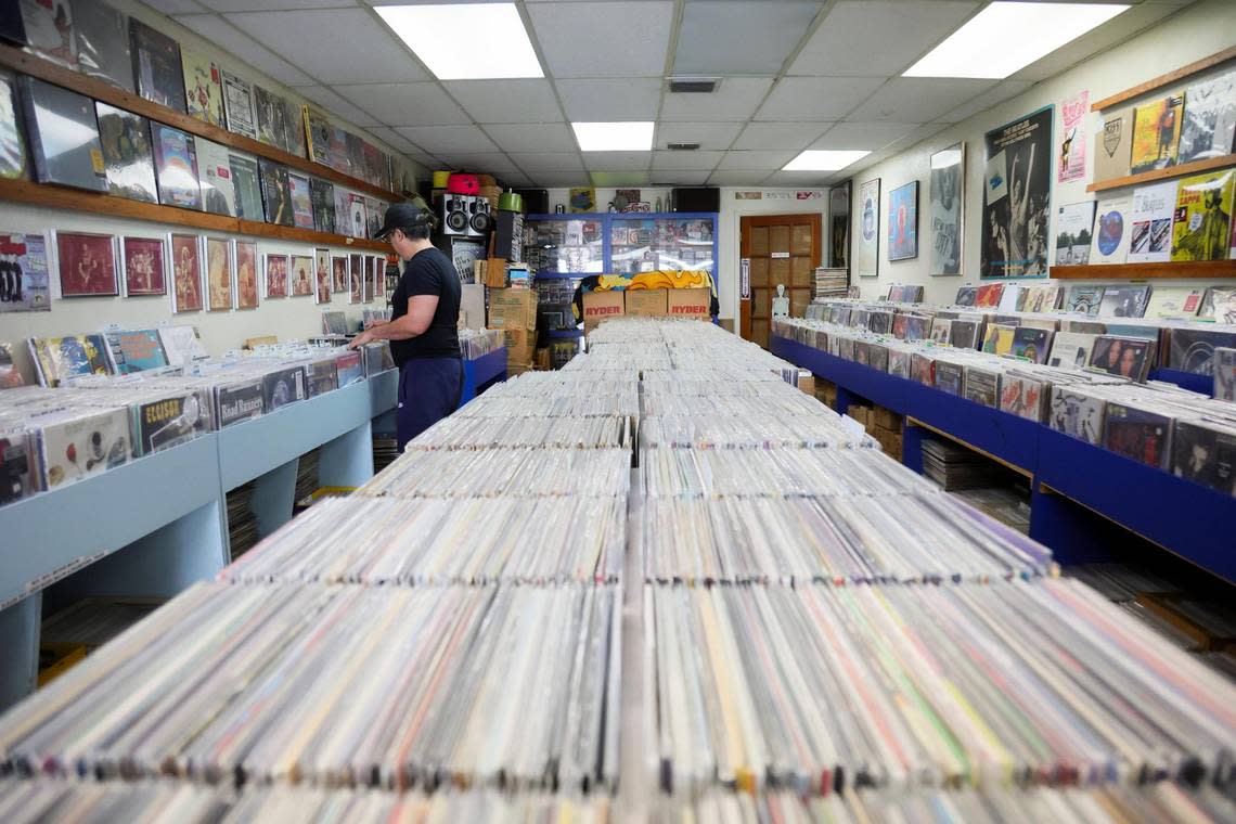 Miles of titles. Daniel Garcia, 50, looks at a record while shopping at Yesterday and Today Records store on west Bird Road at 9274 SW 40th St. in Miami, Florida, Feb. 2, 2024. Y&T is the oldest record store in Miami-Dade County.