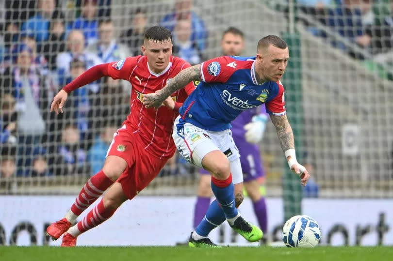 A picture of Linfield's Kirk Millar in action with Cliftonville’s Ronan Hale