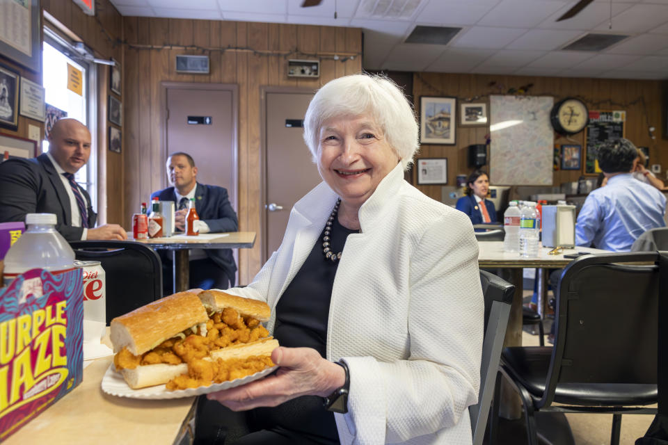 Secretary of the Treasury Janet Yellen smiles as she sits down to eat her shrimp po-boy at Domilise's Po-Boy & Bar Friday, June 30, 2023 in New Orleans. (Chris Granger/The Times-Picayune/The New Orleans Advocate via AP)