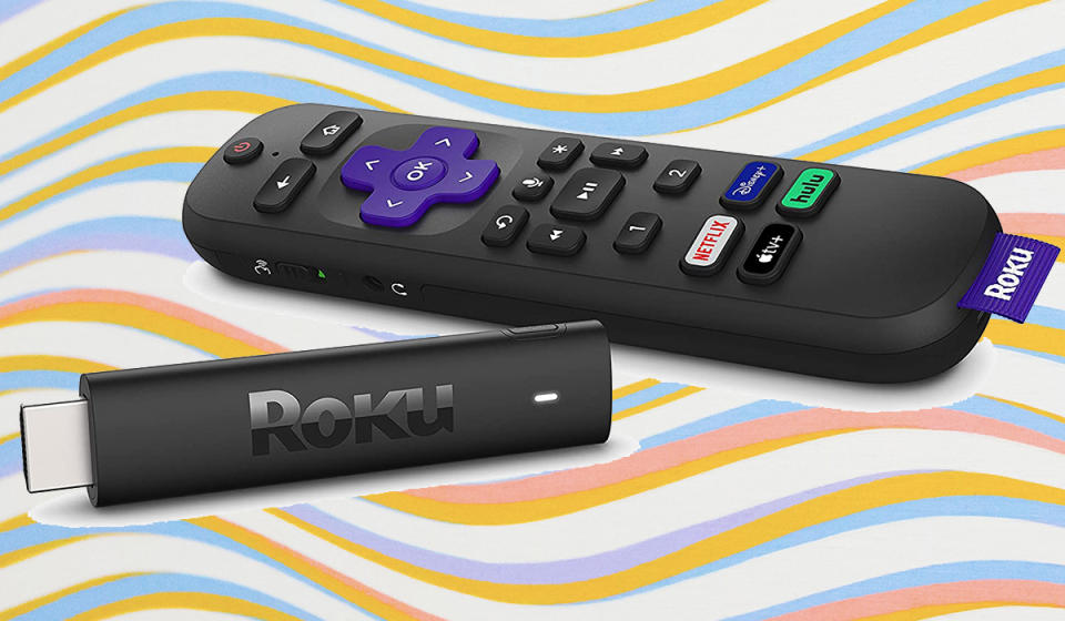 A remote control and HDMI stick on a wavy background