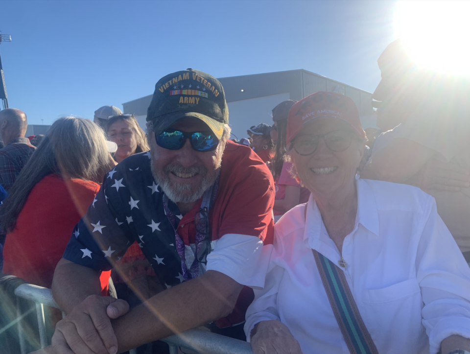 Gil Gouge, 74 and Sharon Falcone, 68, wait to hear former President Donald Trump speak during a rally on Friday, Sept. 23, 2022 at Wilmington International Airport in Wilmington, N.C.