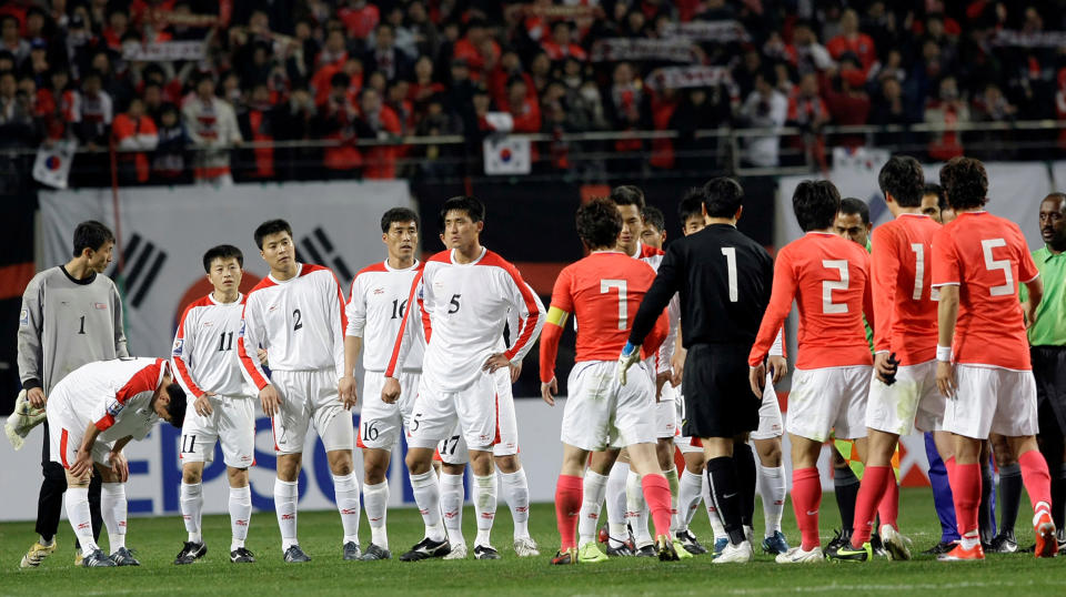 FILE - In this April 1, 2009, file photo, North Korean players, wearing white uniforms, shake hands with South Korean players after their 2010 FIFA World Cup Asia group 2 qualifying soccer match at Seoul World Cup Stadium in Seoul, South Korea. South Korean officials say North Korea has told soccer's Asian governing body it will not participate in World Cup qualifiers next month because of coronavirus concerns. Kim Min-soo, an official from the Seoul-based Korean Football Association, on Tuesday, May 4, 2021, said the Asian Football Confederation has requested North Korea to reconsider its decision. He said the North notified the AFC last week of its intent to drop out of the matches.(AP Photo/ Lee Jin-man, File)