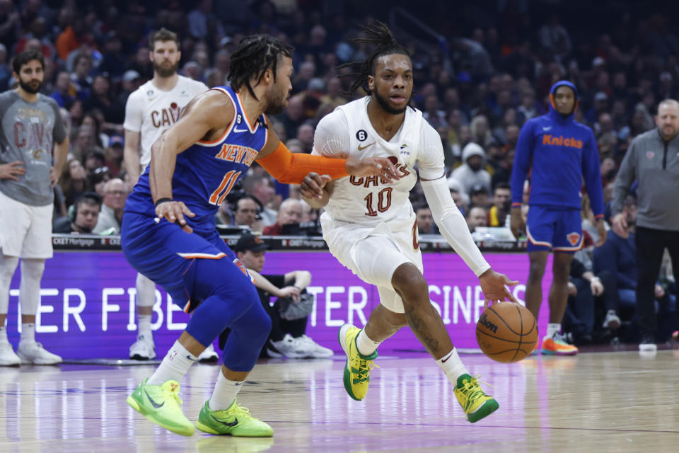 Cleveland Cavaliers guard Darius Garland (10) drives against New York Knicks guard Jalen Brunson (11) during the first half of an NBA basketball game Friday, March 31, 2023, in Cleveland. (AP Photo/Ron Schwane)