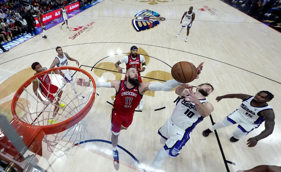 New Orleans Pelicans center Jonas Valanciunas (17) battles for a rebound with Sacramento Kings forward Domantas Sabonis (10) in the second half of an NBA basketball play-in tournament game in New Orleans, Friday, April 19, 2024. The Pelicans won 105-98. (AP Photo/Gerald Herbert)