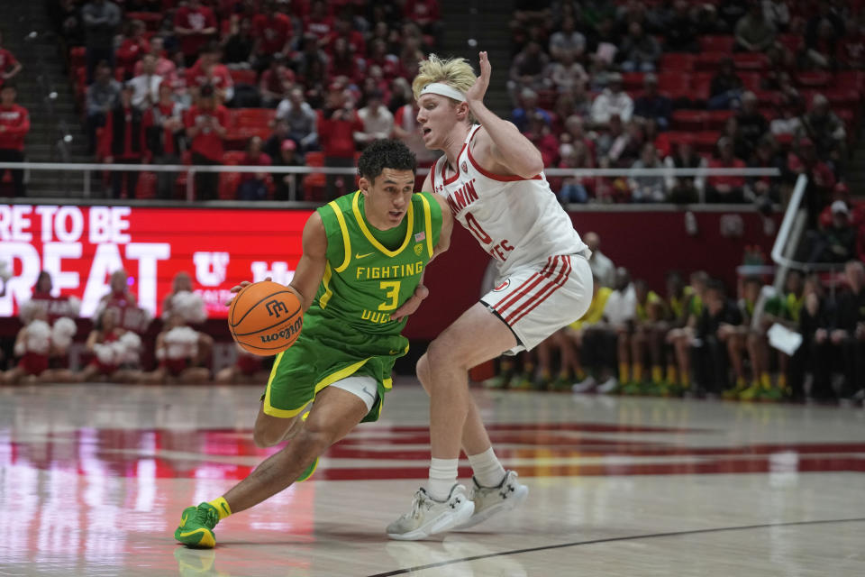 Oregon guard Jackson Shelstad (3) drives as Utah guard Hunter Erickson defends during the first half of an NCAA college basketball game, Sunday, Jan. 21, 2024, in Salt Lake City. (AP Photo/Rick Bowmer)