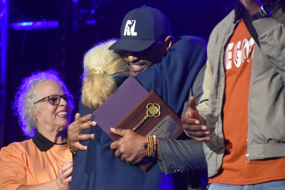 Baltimore Ravens NFL legend Ray Lewis hugs a woman at Dockside's second installment of "Dock Jam" on Saturday, October 7, 2023, in Pocomoke City, Maryland.