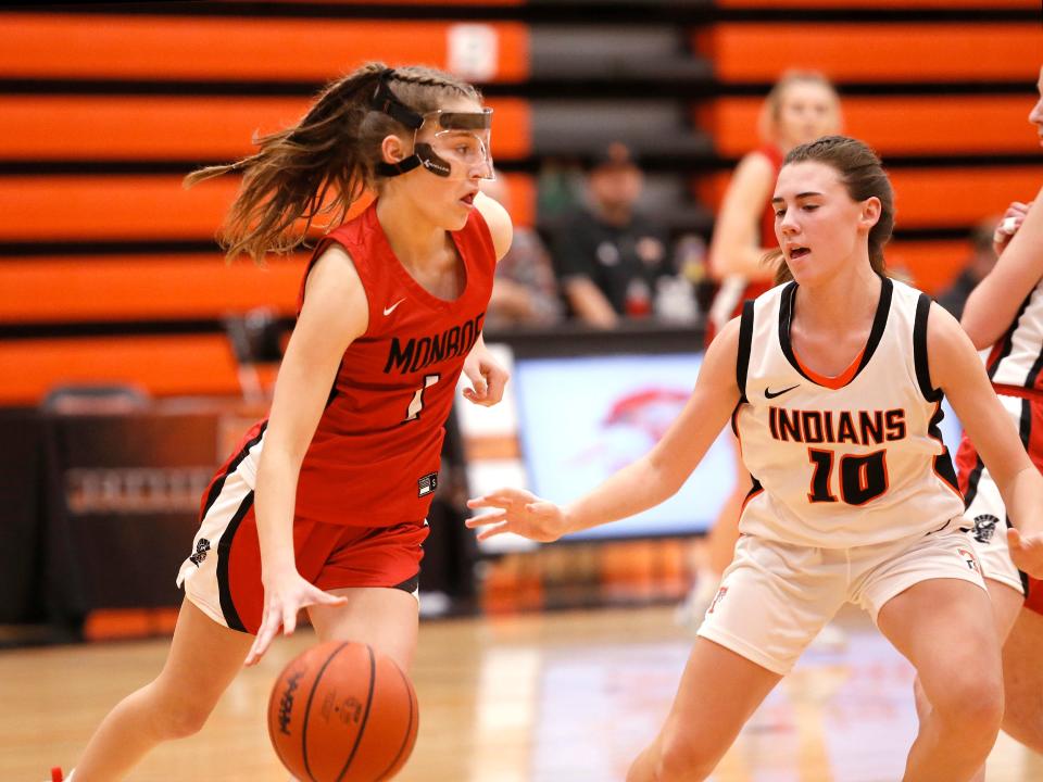 Monroe’s Hayven Neddo is guarded by Chloe Bullinger of Tecumseh Tuesday night in the girls basketball season opener for both schools.