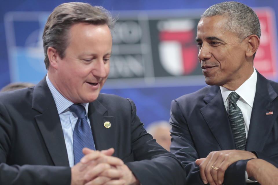 FILE - U.S. President Barack Obama sits next to British Prime Minister David Cameron before the first working session of the North Atlantic Council at the NATO summit in Warsaw, Poland, July 8, 2016. (AP Photo/Markus Schreiber, File)