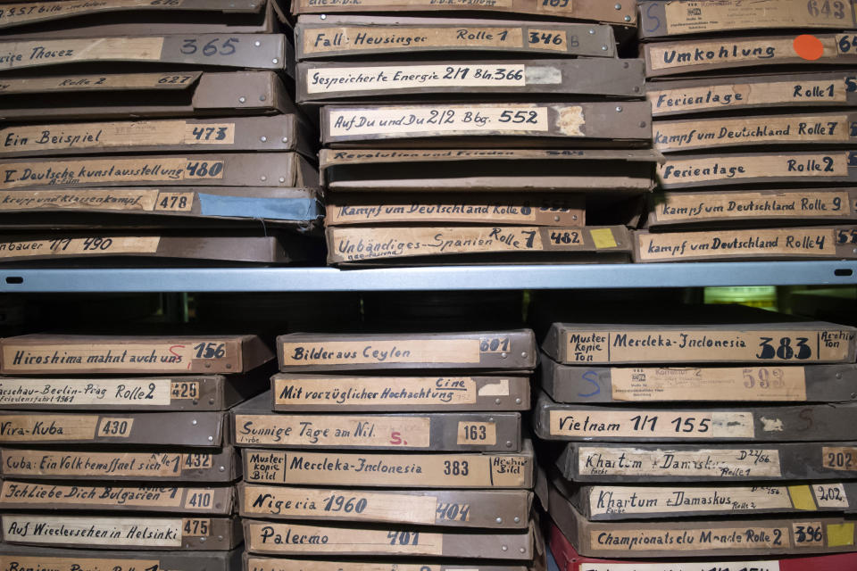 In this Wednesday, June 17, 2020 photo, film boxes are stacked in the archive of PROGRESS Film, in Leipzig, Germany. A new project is underway to digitize thousands of East German newsreels, documentaries and feature films 30 years after Germany’s reunification. The movies that are being scanned, transcribed and posted online provide a look inside a country that no longer exists but was a critical part of the Cold War. (AP Photo/Jens Meyer)