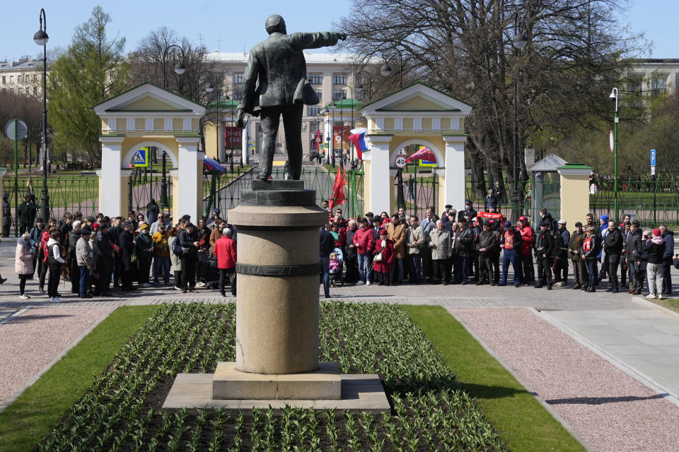 Communists party supporters gather near a statue of Soviet Union founder Vladimir Lenin to mark Labor Day, also known as May Day in St. Petersburg, Russia, Monday, May 1, 2023. (AP Photo/Dmitri Lovetsky)