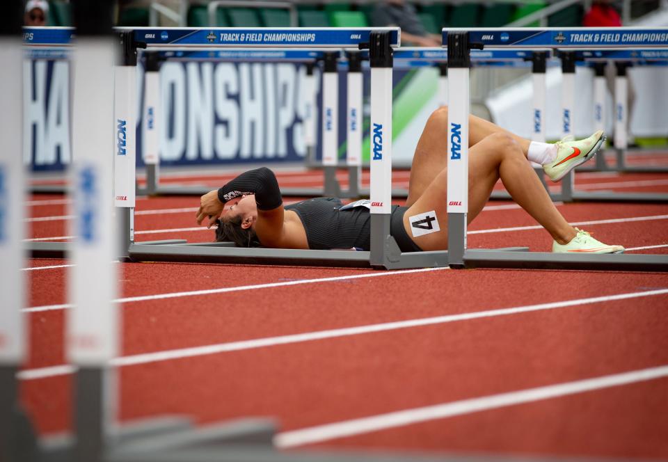 Arkansas’ Yoveinny Mota lays on the track after getting tripped up in the women’s 100 meter hurdles on the second day of the NCAA Outdoor Track & Field Championships Thursday, June 9, 2022 at Hayward Field in Eugene, Ore. 